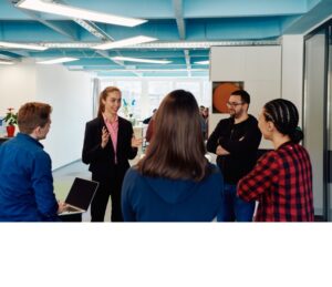 A diverse team of young business people exchanging ideas in a modern startup office.